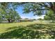 Spacious, well-manicured lawn surrounding a charming home, presenting an inviting exterior view under a sunny sky at 5024 37Th E St, Bradenton, FL 34203