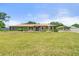 Charming single-story home featuring a well-manicured lawn and blue shutters at 5024 37Th E St, Bradenton, FL 34203