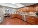 Eat-in kitchen featuring wooden cabinets, stainless steel appliances, and wood flooring at 5024 37Th E St, Bradenton, FL 34203