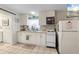 Functional kitchen featuring ample white cabinetry, tile backsplash, and modern appliances at 5024 37Th E St, Bradenton, FL 34203