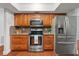Well-equipped kitchen features wood cabinets, stainless steel appliances, and hardwood flooring at 5024 37Th E St, Bradenton, FL 34203