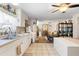 Open-concept kitchen with appliances, white cabinetry, and a view of the open floor plan at 5024 37Th E St, Bradenton, FL 34203