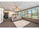 Inviting living room with large windows, a ceiling fan, and neutral decor, creating a warm and welcoming atmosphere at 5024 37Th E St, Bradenton, FL 34203