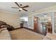 Cozy living room with ceiling fan, french doors, and seamless flow into the dining room at 5024 37Th E St, Bradenton, FL 34203