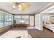 Bright living room featuring large windows, a ceiling fan, and comfortable seating, perfect for relaxing and entertaining at 5024 37Th E St, Bradenton, FL 34203
