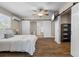 Serene main bedroom with wood flooring, stylish ceiling fan, and elegant barn doors leading to ensuite bathroom at 5024 37Th E St, Bradenton, FL 34203