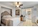 Comfortable main bedroom with a barn door, tile flooring, and seamless bathroom access at 5024 37Th E St, Bradenton, FL 34203