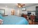 Spacious bedroom featuring hardwood floors, ceiling fan, and a dedicated workspace at 5024 37Th E St, Bradenton, FL 34203
