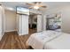 Comfortable bedroom with ample natural light, a ceiling fan, and adjacent closet space and living area at 5024 37Th E St, Bradenton, FL 34203