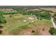 Aerial view of a expansive fenced property with lush pasture and mature trees at 5235 Spencer Parrish Rd, Parrish, FL 34219