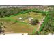 Expansive aerial view showcasing the home, surrounding acreage, and outbuildings within a green-lined property boundary at 5235 Spencer Parrish Rd, Parrish, FL 34219