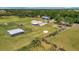 Picturesque property showcasing a lovely home with outbuildings nestled within a sprawling green pasture at 5235 Spencer Parrish Rd, Parrish, FL 34219