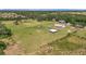 Vast property showcasing a residence, outbuildings, and open pastureland, perfect for agricultural or recreational use at 5235 Spencer Parrish Rd, Parrish, FL 34219
