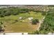 Beautiful acreage with a house, barn, and green pasture, surrounded by trees at 5235 Spencer Parrish Rd, Parrish, FL 34219