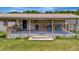 Spacious back deck with an outdoor bar area, seating, and an open-air entertainment space at 5235 Spencer Parrish Rd, Parrish, FL 34219