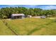 Aerial view of property with a large barn, outbuildings, and a spacious grassy area at 5235 Spencer Parrish Rd, Parrish, FL 34219
