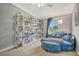 Comfortable bedroom with a reading nook, large window, and ample shelving at 5235 Spencer Parrish Rd, Parrish, FL 34219