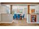 Dining room with hardwood floors, wood trim and pillars, and blue chairs at 5235 Spencer Parrish Rd, Parrish, FL 34219