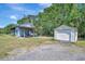 View of detached garage with white door and separate covered area at 5235 Spencer Parrish Rd, Parrish, FL 34219