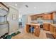 Cozy kitchen featuring wood cabinets, tile flooring and backsplash, and a center island at 5235 Spencer Parrish Rd, Parrish, FL 34219