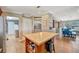 Spacious kitchen flowing into dining area with tile flooring and wood island at 5235 Spencer Parrish Rd, Parrish, FL 34219