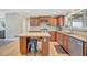 Classic kitchen design featuring wooden cabinets, tile floor and central island with breakfast bar at 5235 Spencer Parrish Rd, Parrish, FL 34219