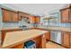 Updated kitchen showcasing custom wood cabinetry and stainless steel appliances at 5235 Spencer Parrish Rd, Parrish, FL 34219