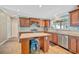 Updated kitchen featuring classic wood cabinets, a kitchen island, and modern stainless steel appliances at 5235 Spencer Parrish Rd, Parrish, FL 34219