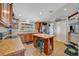 Open kitchen with wood cabinets, tile floors, and a central island with seating at 5235 Spencer Parrish Rd, Parrish, FL 34219