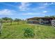 The paddock features a shelter, grass, and fencing, providing ample space for animals at 5235 Spencer Parrish Rd, Parrish, FL 34219