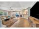 Bright living room with hardwood floors, gray walls, an open layout, and a view of the dining area at 5235 Spencer Parrish Rd, Parrish, FL 34219