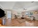 Inviting living room featuring a comfy sectional sofa, wood floors, and an area rug at 5235 Spencer Parrish Rd, Parrish, FL 34219