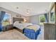 Comfortable main bedroom features natural light, stylish furniture, and soothing decor at 5235 Spencer Parrish Rd, Parrish, FL 34219