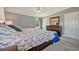 Comfortable main bedroom features neutral walls, stylish furniture, and carpeted floors at 5235 Spencer Parrish Rd, Parrish, FL 34219