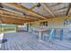 Covered porch with string lights and outdoor seating is perfect for entertaining or relaxing at 5235 Spencer Parrish Rd, Parrish, FL 34219