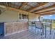 Covered porch features a built-in bar, sink, seating, and views of the surrounding landscape at 5235 Spencer Parrish Rd, Parrish, FL 34219