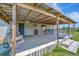 Covered porch offers a swing, bar seating, and ample space for outdoor enjoyment at 5235 Spencer Parrish Rd, Parrish, FL 34219