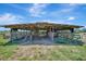 Livestock shelter, with metal roof and wood frame, has a dirt floor and animal pens at 5235 Spencer Parrish Rd, Parrish, FL 34219
