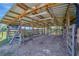 The interior of the shelter features metal roof and wood frame, with a dirt floor and animal pens at 5235 Spencer Parrish Rd, Parrish, FL 34219