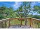 Relaxing on the wooden treehouse deck, enjoying the lush green landscape at 5235 Spencer Parrish Rd, Parrish, FL 34219