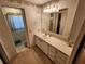 Bathroom featuring a sink, drawers, and a mirror leading into another bathroom area at 5408 Chateau Ln, Bradenton, FL 34207