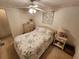 Comfortable bedroom with a bed, a ceiling fan, and a dresser with a lamp on the bedside table at 5408 Chateau Ln, Bradenton, FL 34207