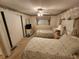 This bedroom is furnished with two cozy beds, a ceiling fan, and a window with charming curtains at 5408 Chateau Ln, Bradenton, FL 34207
