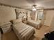 Bright bedroom featuring two cozy beds, a window with curtains, and plenty of natural light at 5408 Chateau Ln, Bradenton, FL 34207