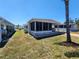 Cozy home featuring a screened in porch and an adjacent covered carport for convenient parking at 5408 Chateau Ln, Bradenton, FL 34207