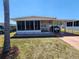 Charming single-story home with covered parking and an inviting screened-in porch for outdoor relaxation at 5408 Chateau Ln, Bradenton, FL 34207