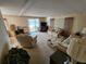 Cozy living room with comfortable seating, plush carpet and natural light from the sliding doors at 5408 Chateau Ln, Bradenton, FL 34207