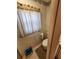 A compact toilet area with a toilet, toilet paper holder, and neutral-colored tiling at 5408 Chateau Ln, Bradenton, FL 34207