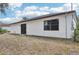 Back exterior featuring sliding glass door with windows, on a home with a brown roof at 5414 Ansonia Ter, North Port, FL 34287