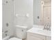 Bright bathroom features a white vanity with a mirror and a bathtub with white tile surround at 5414 Ansonia Ter, North Port, FL 34287